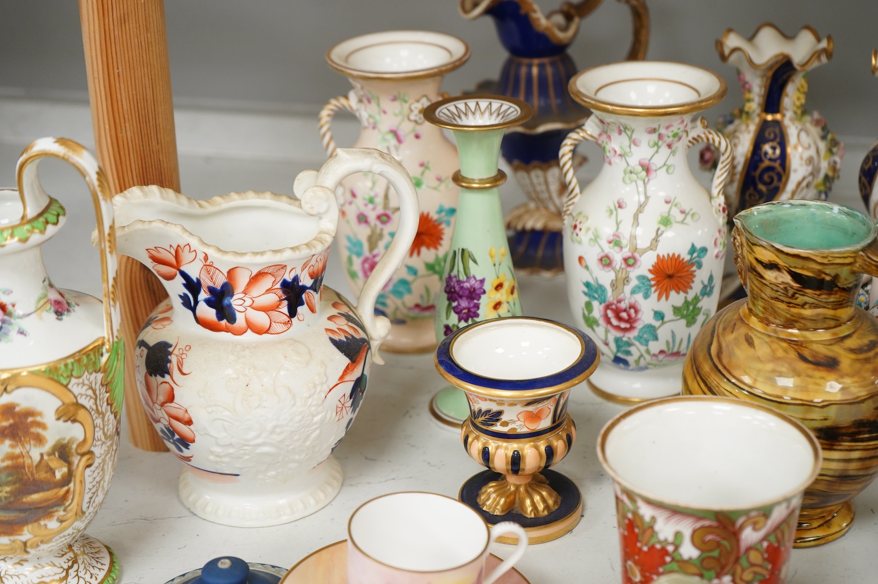 Large group of 19th/20th century English ceramics, to include a Rockingham basket, other English porcelain flower encrusted vessels, a Copeland and Garrett ewer, a Minton Sevres style beaker, a Wedgwood agate ware jug, R